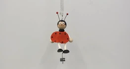 Mass dependence of the period of the motion of a toy suspeded on a spring